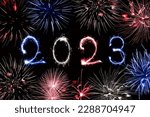 2023 written with sparkles and fireworks, us or French flag colors, July 4 or 14 national day celebration