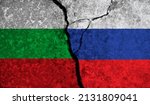 Political relationship between Bulgaria and russia. National flags on cracked concrete background