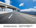 Asphalt highway and bridge under blue sky