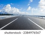 Straight asphalt highway and skyline under blue sky