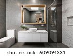 Modern grey designer bathroom with herringbone shower tiling