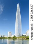 Small photo of Beautiful view of skyscraper by lake at downtown of Seoul, South Korea. Amazing modern tower on blue sky background. Wonderful sunny cityscape. Seoul is a popular tourist destination of Asia.