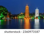 Small photo of Beautiful night view of the Sun and Moon Twin Pagodas at Shanhu Lake (Fir Lake). Gold and Silver Pagodas illuminated at downtown of Guilin, China. Guilin is a popular tourist destination of Asia.