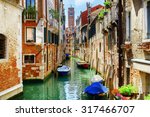 The Rio di San Cassiano Canal with boats and colorful facades of old medieval houses in Venice, Italy. Bell-tower of San Cassiano (Church of Saint Cassian) is visible in background.