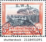 Small photo of South Africa - circa 1931 : a postage stamp from South Africa, showing houses in the colonial period with trees. Groote Schuur, the residence of Cecil Rhodes . Overprint SWA