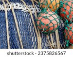 View of fishing nets rolled up on the large drum of a fishing boat.