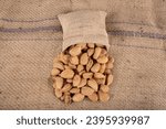 Small photo of Shelled Almonds, Heap of natural organic almonds with hard shell. Raw fresh almonds with shell. closeup of a pile of almonds in shell after harvesting.