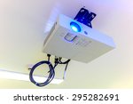 Small photo of A white overhead projector on ceiling indoors