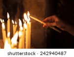 Woman Lighting Candles  In A...