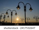 Small photo of Curved artistic lampposts in Liberty State Park in Jersey City New Jersey at sunrise