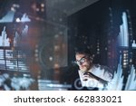 Concept of digital diagram,graph interfaces,virtual screen,connections icon.Young finance analist working at modern office.Man using contemporary laptop at night,blurred background.Horizontal
