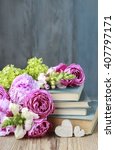 Old Books And Bouquet Of Flowers