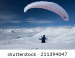 Paraglider In Winter Mountains...