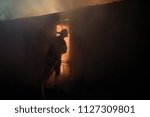 silhouette of fireman fighting... | Shutterstock . vector #1127309801