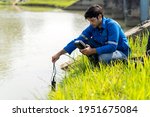 Small photo of A technician use the Professional Water Testing equipment to measure the water quality at the public canal. Portable multi parameter water quality measurement. Water quality monitoring concept.