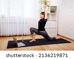 Woman Exercising At Home In...