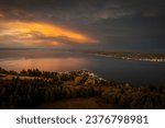 Small photo of Dramatic sunrise over the east side of Lummi island, Washington. The small island community, called Lane Spit, is illuminated by the beautiful morning light on this fall day in the Pacific Northwest.