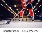 Close up of hockey player skating with stick and puck.