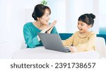 Small photo of Asian little girl studying how to use laptop PC. Computer programing class. Mother and daughter. Cram school. Tutor.