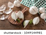 Composition with fresh cut onion and spices on wooden table