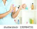 woman testing perfume on shop... | Shutterstock . vector #150984731