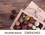 Box filled with chocolates on wooden rustic background