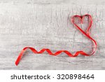 red heart ribbon on grey... | Shutterstock . vector #320898464