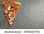 Pizza slice with seafood, red pepper and olives on grey background