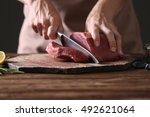 Butcher Cutting Pork Meat On...