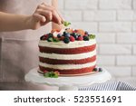 Woman decorating delicious cake