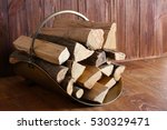 Basket With Firewood On Wooden...