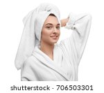 Beautiful young woman in bathrobe after shower on white background