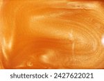 Small photo of Golden shimmer liquid, luxurious background, shimmering texture, cosmetic art