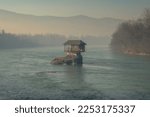 Lonely house on the Drina river in Bajina Basta at winter morning fog, Serbia