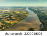 Aerial high view of colorful fields on high bank of Danube river in Serbia