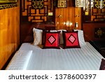 Small photo of Junk boat tours Ha Long Bay Cruises. Vintage Interior of a cabin bedroom on cruise ship staterooms and suites. Cruise in Halong Bay Tour. Vietnam
