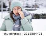 Small photo of Young woman having itching eyes health problem. Sick woman in winter snow touching her sensitive eye