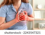 Young woman pressing on chest with painful expression. Severe heartache, having heart attack or painful cramps, heart disease.