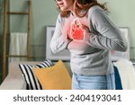 Small photo of Young woman pressing on chest with painful expression. Severe heartache, having heart attack or painful cramps, heart disease