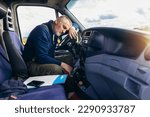 Small photo of Exhausted truck driver falling asleep on steering wheel. Tiredness and sleeping concept.
