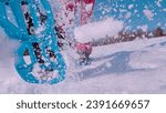 Small photo of CLOSE UP, LOW ANGLE VIEW: Fresh snow flying behind a young lady running on snowy meadow in blue snowshoes. Following unrecognizable woman snowshoeing through winter countryside on a nice sunny day.