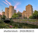 Small photo of Colorful sunset clouds over medieval Westgate Towers and Guildhall in Canterbury. Amazing view of blooming flowers on the banks of River Stour that flows slowly through picturesque historic town.