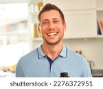 Small photo of man holding a pill between his teeth, with a focused yet playful expression. While the pill could be medication or vitamins, its negative connotations add ambiguity to the man's well-being
