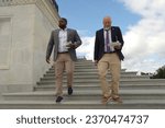 Small photo of WASHINGTON, DC - September 30, 2023: U.S. Reps. Byron Donalds (R-Fla.) and Chip Roy (R-Tex.) walk down the Capitol steps with their lunches after the vote to avert a government shutdown.