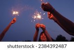 Small photo of Sparkler party. Girls have fun in nature with sparklers. Bengali flicker. Fun party with bright sparklers in hands. People fun night . Group happy young girls play sparklers on background of night sky