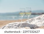 glasses of white wine on the beach