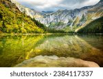 Small photo of Avalanche Lake cliffs, basin, lake and waterfall in Glacier National Park, Montana. Avalanche Lake is southwest of Bearhat Mountain and receives meltwater from Sperry Glacier.
