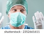 Small photo of Close-up of a surgeon, noticing something amiss with his gloves. Individual expertise can falter when provided subpar equipment. Blame remains ambiguous, but insurance could help