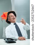 Small photo of Elderly man in office with jester hat teases you, but he will face repercussions for his unprofessional conduct, realizing his disrespect was mistaken