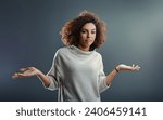 Small photo of Curly-haired woman presents a nonchalant shrug, her expression a mix of indifference and query